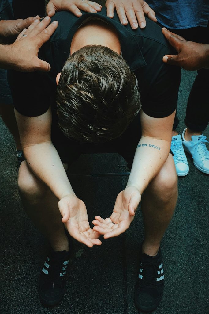 a man being prayed for